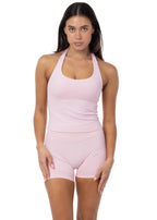 Woman wearing a pink athletic outfit on a white background