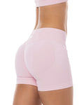Pink high-waisted shorts worn by a person on a white background